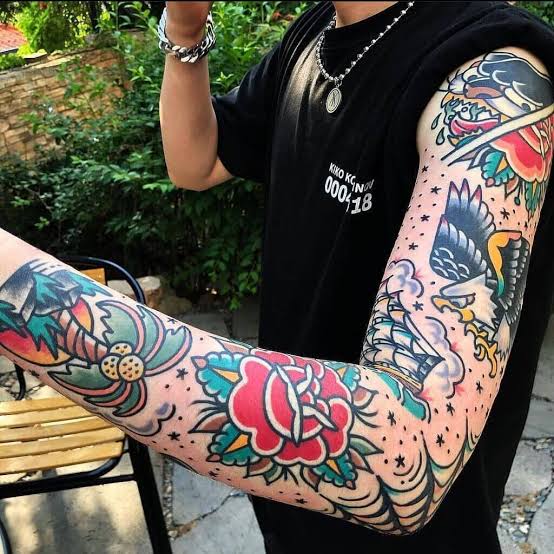 american traditional tattoo in full arm